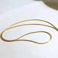 Close-up of a gold double-layer snake chain necklace with high-polish metallic texture - Gold Round Snake Chain