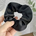 Elegant black satin scrunchie with white stitched edges and smooth pleated texture - Black
