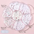 Close-up of iridescent and matte white heart nail charms in a flower storage box - MH-04 White & Aurora Heart