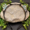 Detail of blue raw crystal cat ear headband with wire-wrapped stones on a rock - Light Blue Crackle Cat Ears