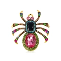 Close-up of spider brooch with colorful crystals and pink gemstone on golden base - Magenta