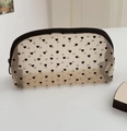Close-up of semi-transparent mesh makeup bag with black heart patterns and zipper - Flocked Heart Beige (Semicircle)