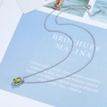 Macro detail of silver emerald-cut olive green zircon pendant on a fine link chain - Olive Green Zirconia
