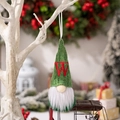 Green knitted Christmas gnome ornament with red embroidered letter W hanging on a branch - Letter W Style