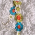 Handmade crochet floral headband with colorful blue, green, and orange woven flowers - Green Large Flower