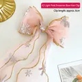 Pink ribbon bow hair clip for girls featuring silver snowflake prints and gold trim - Light Pink Streamer Bow Hair Clip (A190-08)