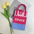 Detailed view of the colorful zigzag knit pattern and the Grace logo on the handbag - Color Block Pink-Grace
