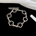 Close-up of silver hollow flower bracelet with lobster clasp and extension chain - Bracelet - Silver - Flower