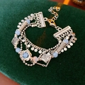 Detail of vintage multi-layer bracelet with blue beads on dark green velvet - Silver-Blue