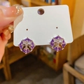 Macro detail of silver cross stud earrings with purple zircons on white cardboard - 32# Silver Pin Silver Purple