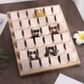 Bamboo 36-slot earring display tray with white jewelry cards on a dark wood table - 36 Slots - Beige