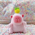 Pink Capybara plush keychain with yellow pineapple hat accessory in colorful bubble background - Pink Pineapple Style + Bead Chain