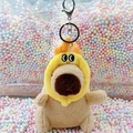 Plush capybara keychain with yellow duck hat in a jar of colorful foam balls - Dragon Horn Hat Light Brown + Silver Clip