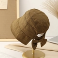 Quilted warm winter bucket hat in brown with a large decorative bow on the back - M / Khaki