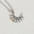 Silver crescent moon necklace featuring micro-set zircons and eight elegant white pearls - Silver Pearl Moon