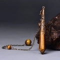 Close-up of tiger eye hexagonal prism pendant with antique bronze filigree cap on a chain - Antique Bronze Tiger Eye
