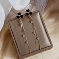 Elegant gold and black heart clover tassel earrings with rhinestones on a jewelry box - Black Heart Clover (E248) / Black & Gold