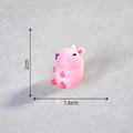 Miniature pink Capybara resin figure with luminous finish measuring 2cm by 1.6cm - Solid Pink-Holding Belly