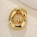 Macro shot of 18k gold plated balloon style letter G pendant with glossy finish - Letter G