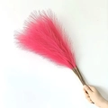 Hand holding a bundle of bright pink artificial pampas grass for boho home decor - 53-55cm / Watermelon red
