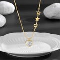 Gold beaded chain necklace with heart shell pendant and three star charms on white ceramic - Star Heart Necklace / Gold