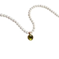 Detail of white pearl necklace featuring a round green gemstone pendant in gold frame - August Peridot