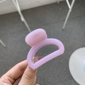 Detail shot of a matte pink-purple plastic hair claw clip with a strong metal spring - Taro Purple