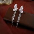 Macro shot of silver zircon butterfly tassel clip earrings on premium leather texture - Ear Clip - Silver