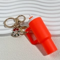 Mini orange Stanley-style tumbler keychain with silicone material and gold metal ring - Christmas Orange