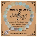 Detail view of 8mm pink zebra stone music bracelet with treble clef charm on display card - Amazonite Bracelet