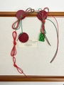 Detailed shot of handmade woven red rope with green Double Happiness character charm - Red Green Cord Asymmetric Earrings / Red Green