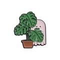 Pink cartoon ghost enamel pin hiding behind green monstera plant leaves in a pot - Ghost Monstera