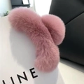 Detail showing plush pink faux rabbit fur hair claw clip resting on a gift bag - Faux Fur / Dusty Pink