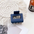 Blue rectangular matte hair claw clip on a beige woven mat with decorative background - Small Matte Square Claw-Navy Blue
