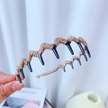 Beige padded fabric headband with inner grip teeth shown in close-up detail view - Plain Style / Coffee Solid