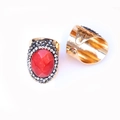 Detailed macro view of gold-plated ring featuring red agate stone and faceted crystals - Red