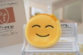 Detailed close-up of a yellow plush emoji coin purse with a zipper on a white wooden bench - Style 5 (Shy Smile)