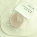 Single lavender tealight candle in clear plastic packaging with a small white card - Cinnamon (Amber Ebony)