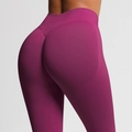 Macro shot of high-waisted seamless yoga pants featuring V-shaped push-up scrunch detail - Wild Berry