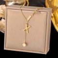 Close-up of golden letter X pendant and cube bead on a modern stainless steel chain - Letter X-Gold