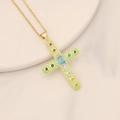 Detail of vintage gold cross pendant with green enamel and colorful inlaid gemstones - Green