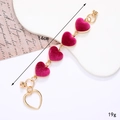 Golden zinc alloy phone chain with magenta velvet heart charms and hollow pendant 14cm - Purplish Red