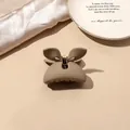 Macro view of matte khaki butterfly hair claw clip with golden metal spring detail - Milk Coffee Matte-Butterfly