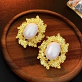 Macro shot of French vintage gold leaf earrings with large round pearls on wooden stand - 925 Silver Earring Post / Gold Geometric