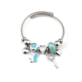 Detail of silver beaded bracelet with heart charms and a key pendant on twisted wire band - Blue