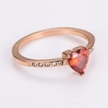 Close-up of rose gold heart ring with red crystal and white zircon side stones - Rose Gold (Red Zirconia)
