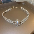 Double-layered vintage pearl necklace with a gold-tone pendant and crystal accents - 29# Necklace - White