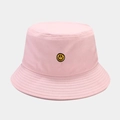 Close-up of the yellow smiley face embroidery on a pink cotton outdoor bucket hat - One Size / Light Pink