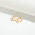 Macro shot of gold heart earrings with centered white pearl and small zircon stones - Hollow Pearl