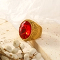 Detailed macro shot of a gold punk ring featuring a faceted red oval gemstone and textures - US 6 / Gold with Dark Red Gemstone